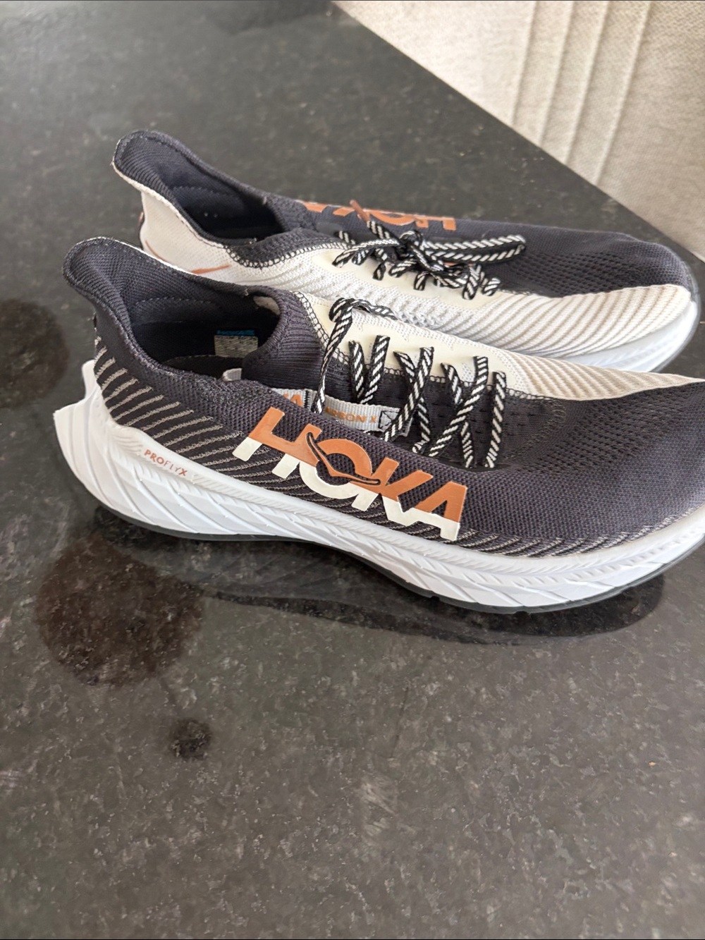 Hoka One One Men's Black and White Running Shoes with Orange Logo